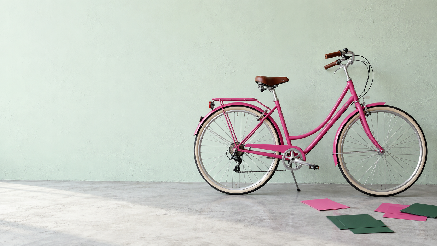 A pink bicycle in a light-filled studio